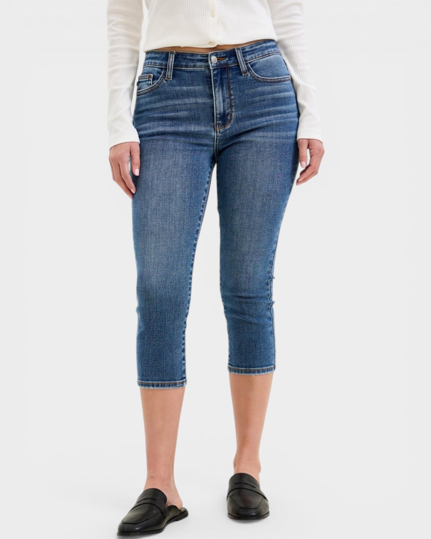 Person wearing blue jeans on a white background