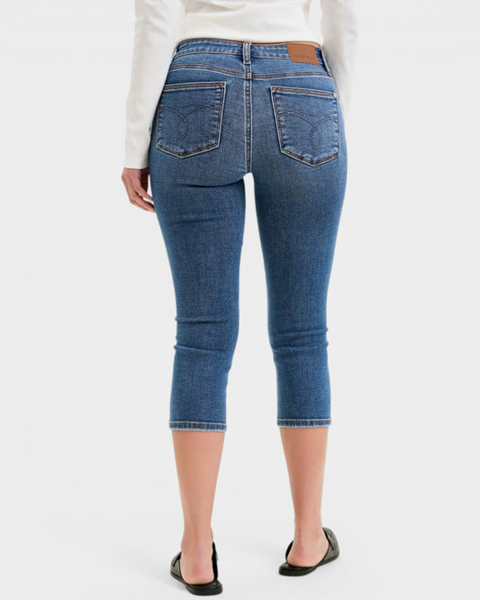 Blue jeans worn by a person on a white background