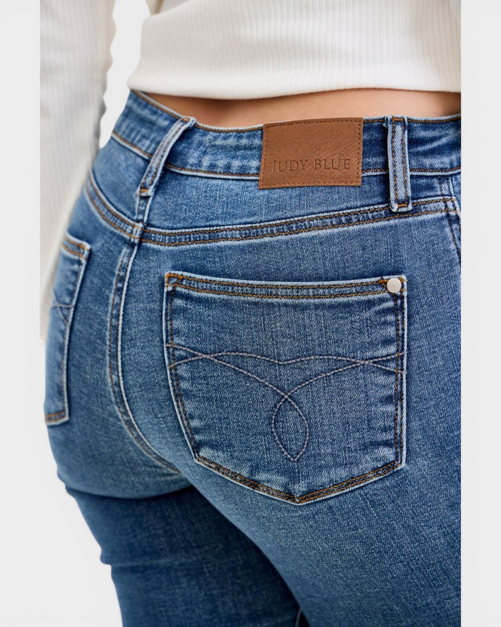 Blue jeans with a brand label on a white background