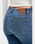 Blue jeans with a brand label on a white background
