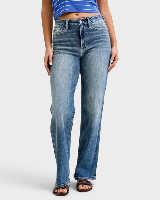 Person wearing blue jeans on a white background
