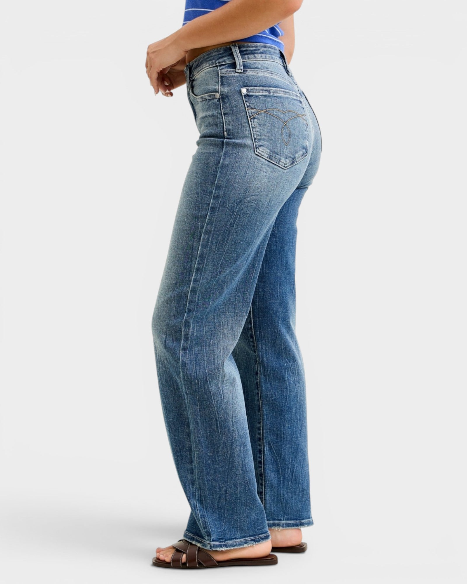 Person wearing blue jeans on a white background