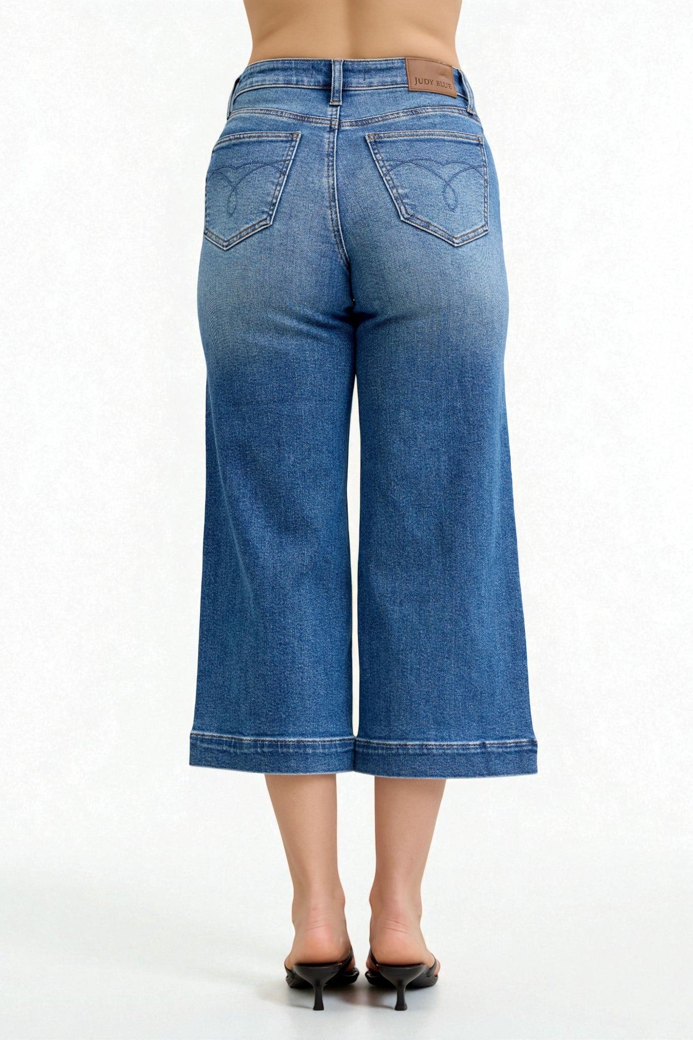 Blue denim wide-leg jeans on a white background