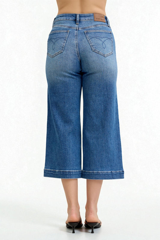 Blue denim wide-leg jeans on a white background