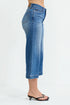 Blue jeans worn by a person on a white background