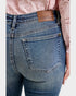 Blue jeans with a Judy Blue patch on a white background