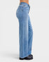 Blue jeans worn by a person on a white background
