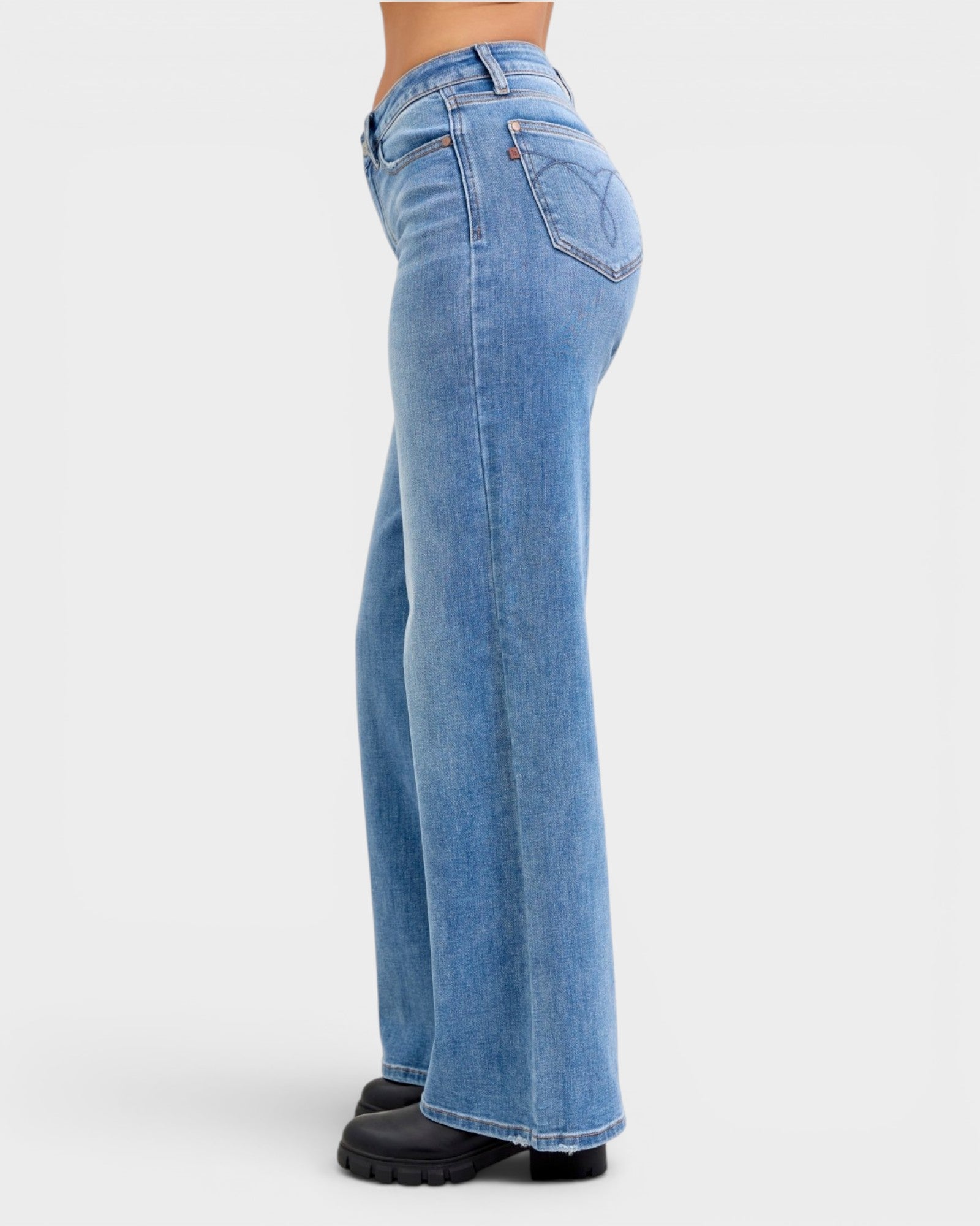 Blue jeans worn by a person on a white background