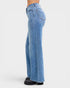 Blue jeans worn by a person on a white background