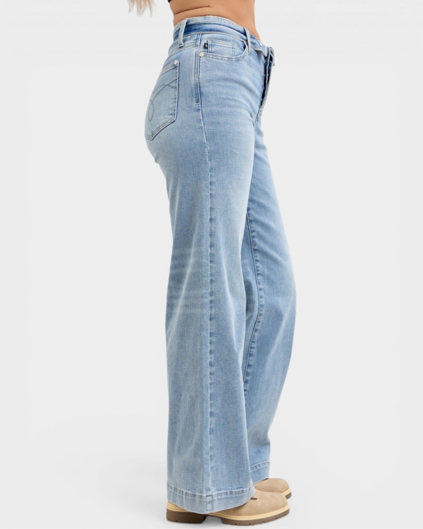 Light blue jeans worn by a person on a white background