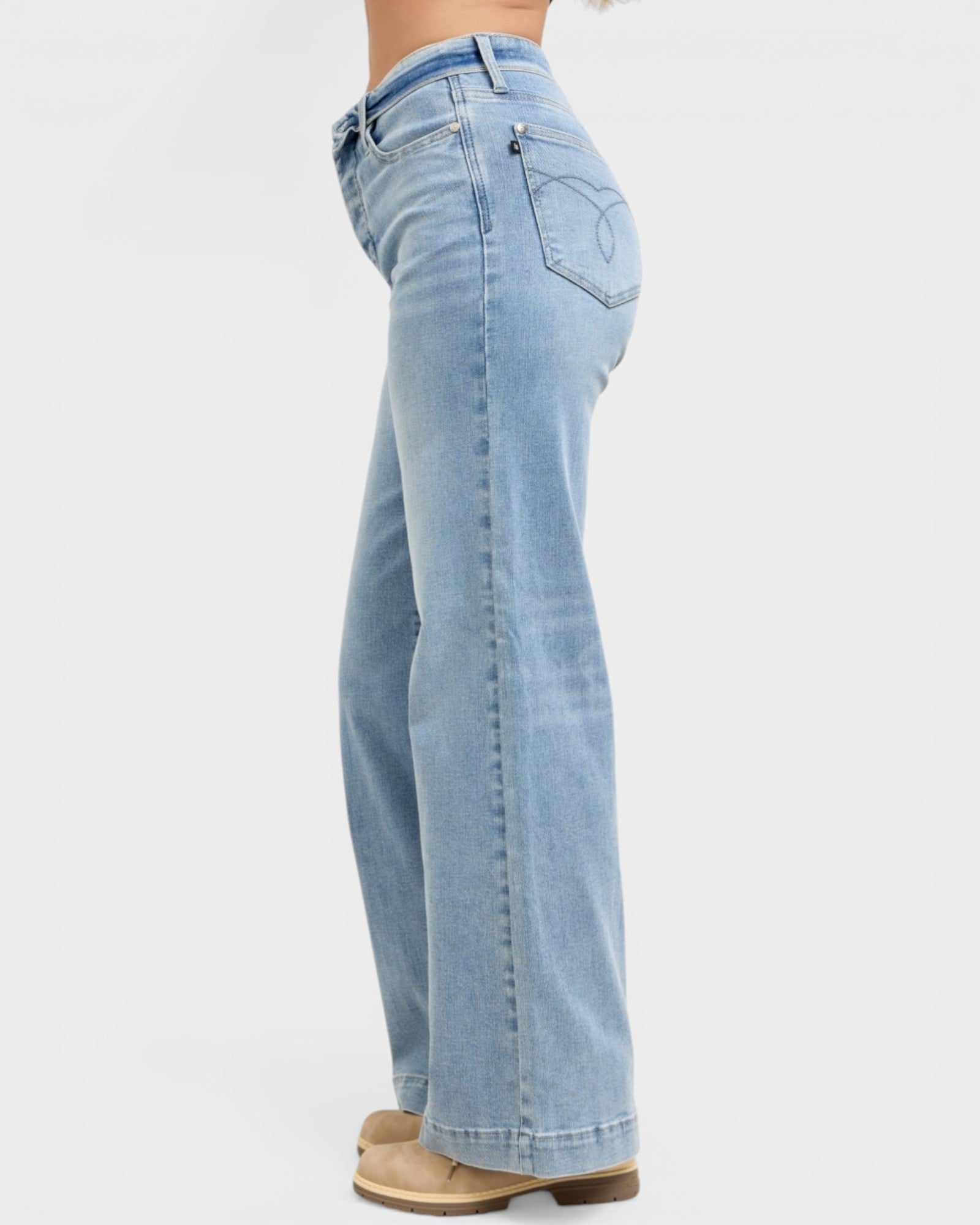 Light blue jeans worn by a person on a white background