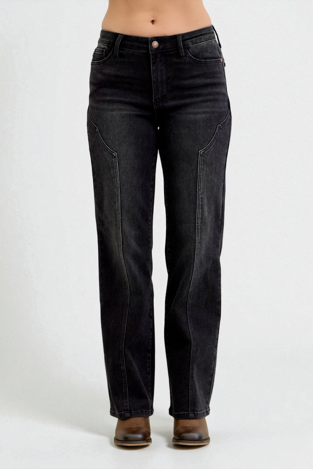 Black jeans worn by a person on a white background