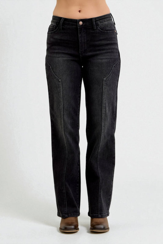 Black jeans worn by a person on a white background