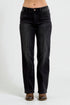 Black jeans worn by a person on a white background
