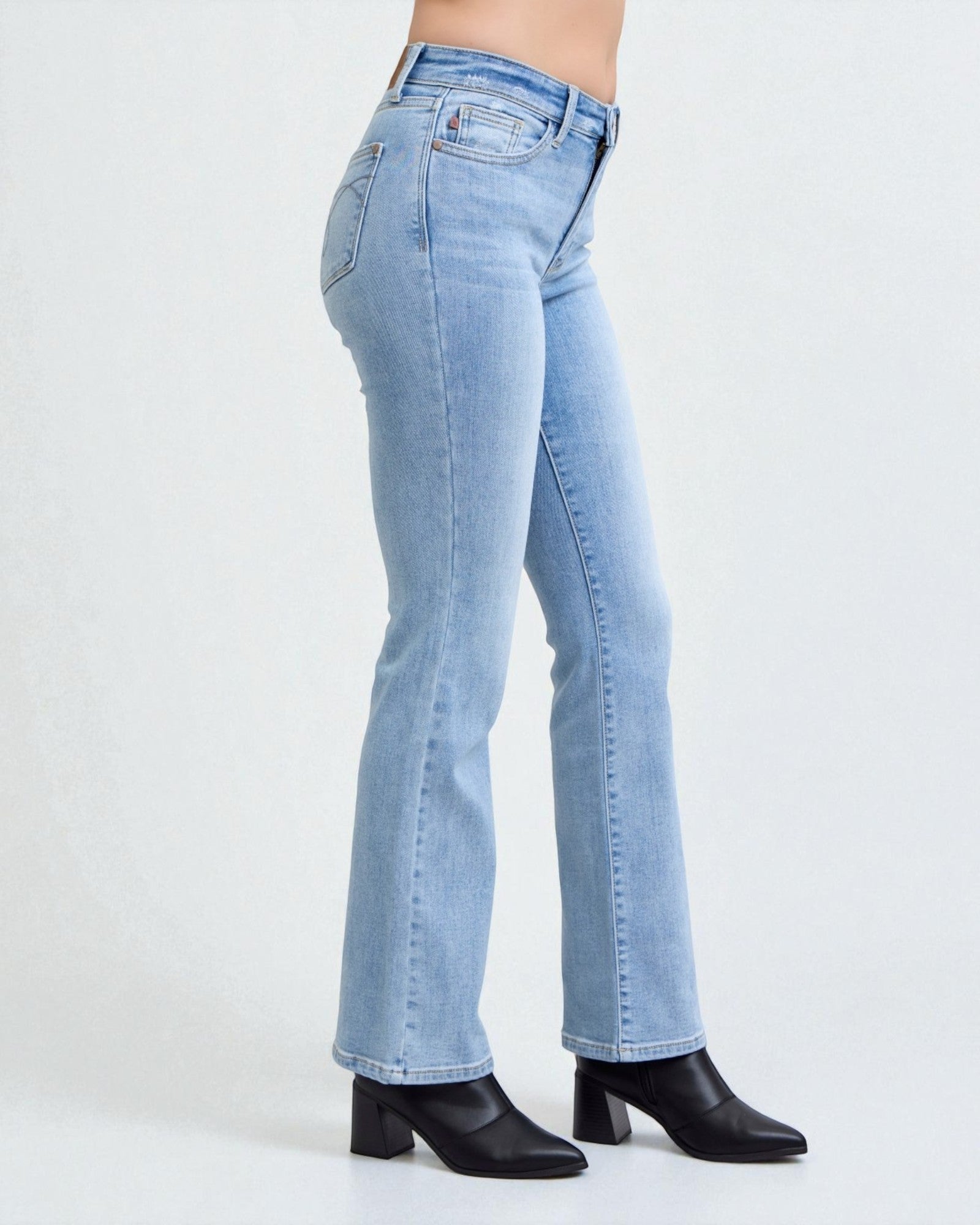 Light blue jeans worn by a person on a white background