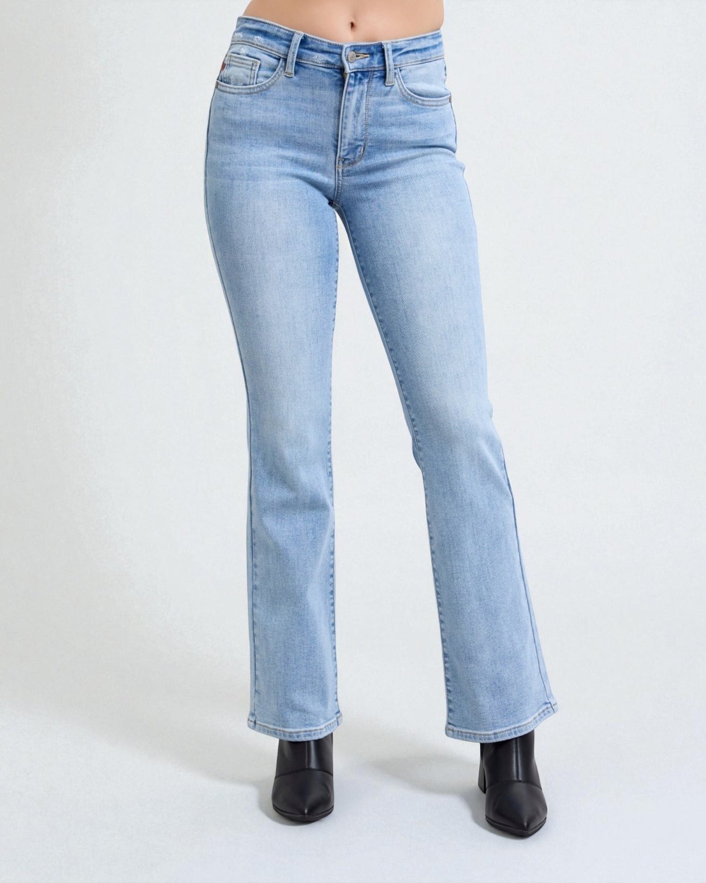 Light blue jeans worn by a person on a white background