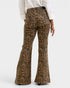 Leopard print flared pants worn by a person on a white background