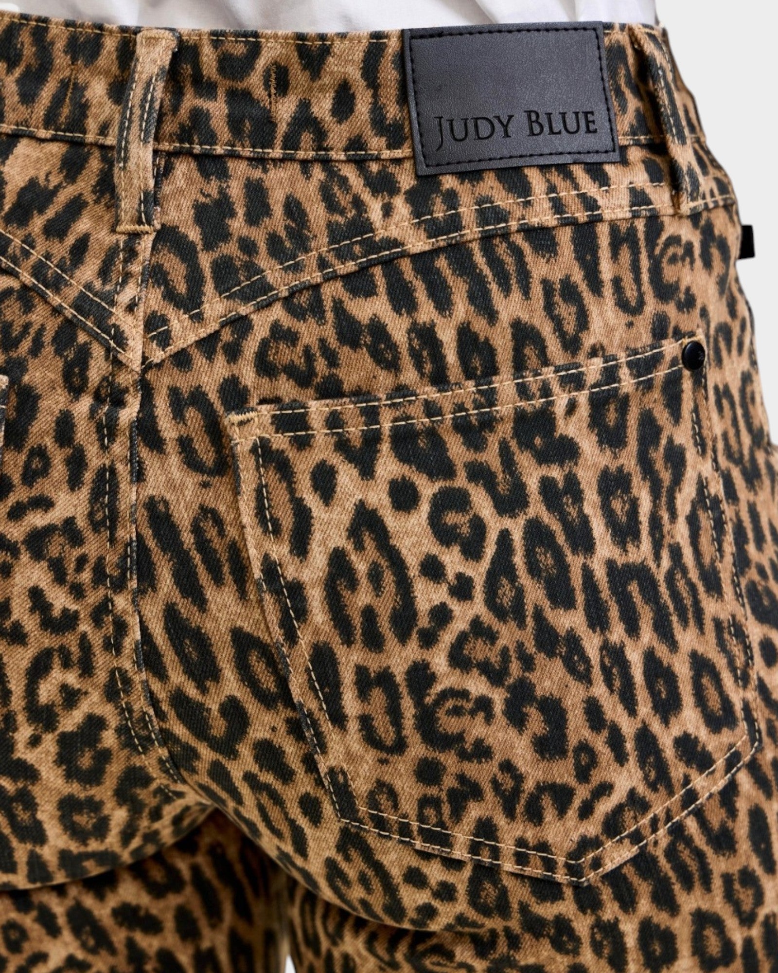 Leopard print pants with a Judy Blue label on a white background