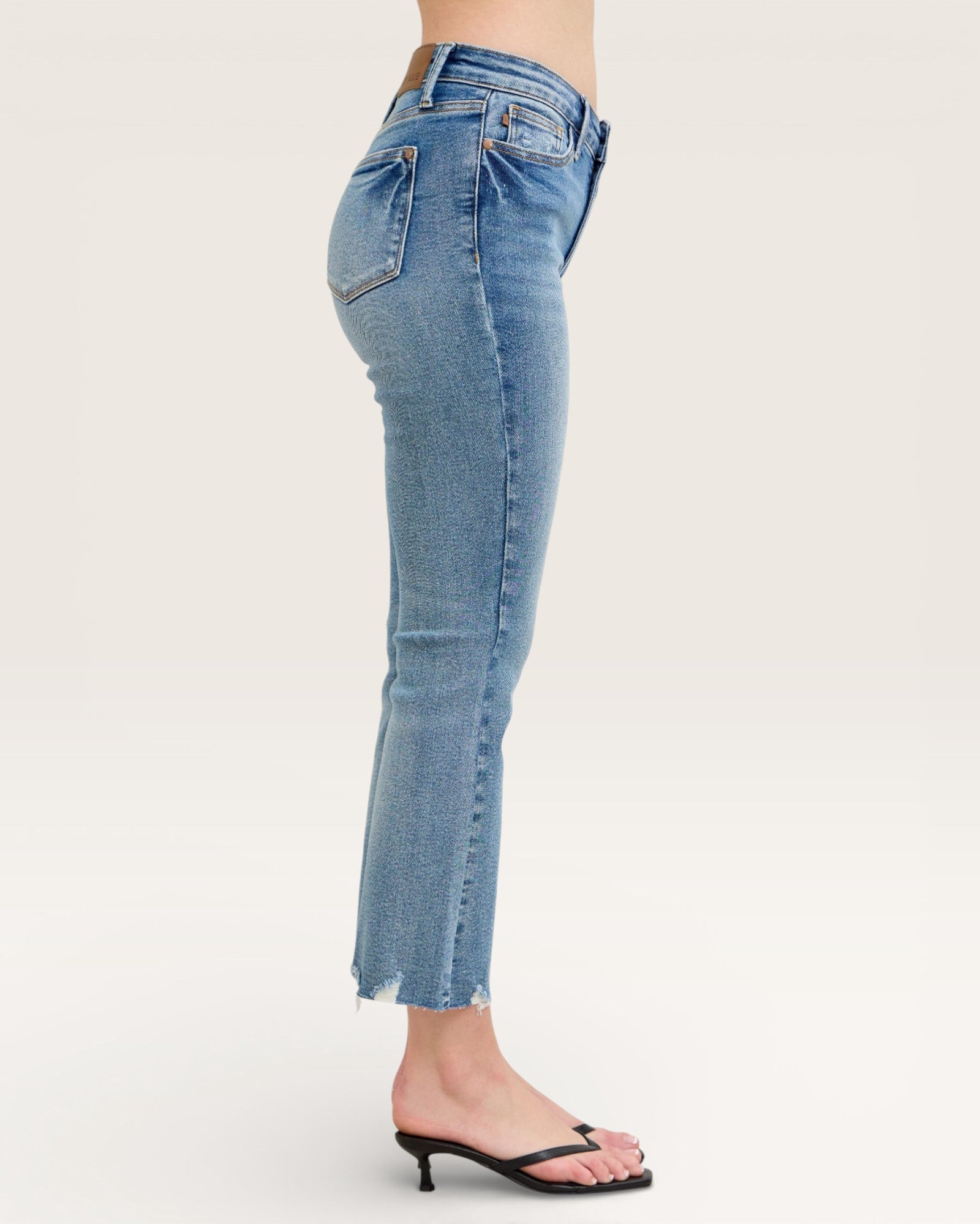 Light blue jeans worn by a person on a white background
