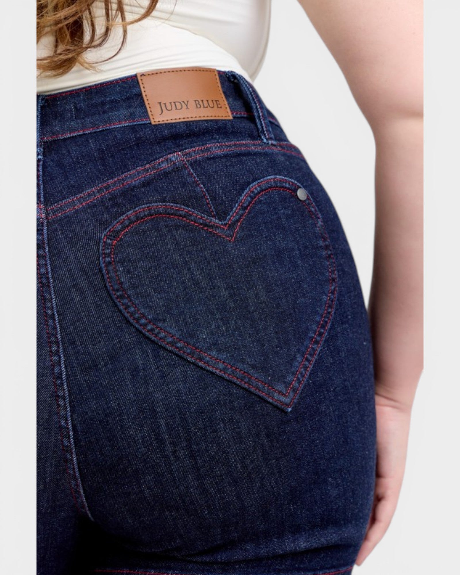 Blue jeans with a heart-shaped pocket and 'Judy Blue' brand label.