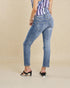 Person wearing blue jeans and a striped top on a beige background
