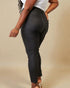 Person wearing black pants on a beige background