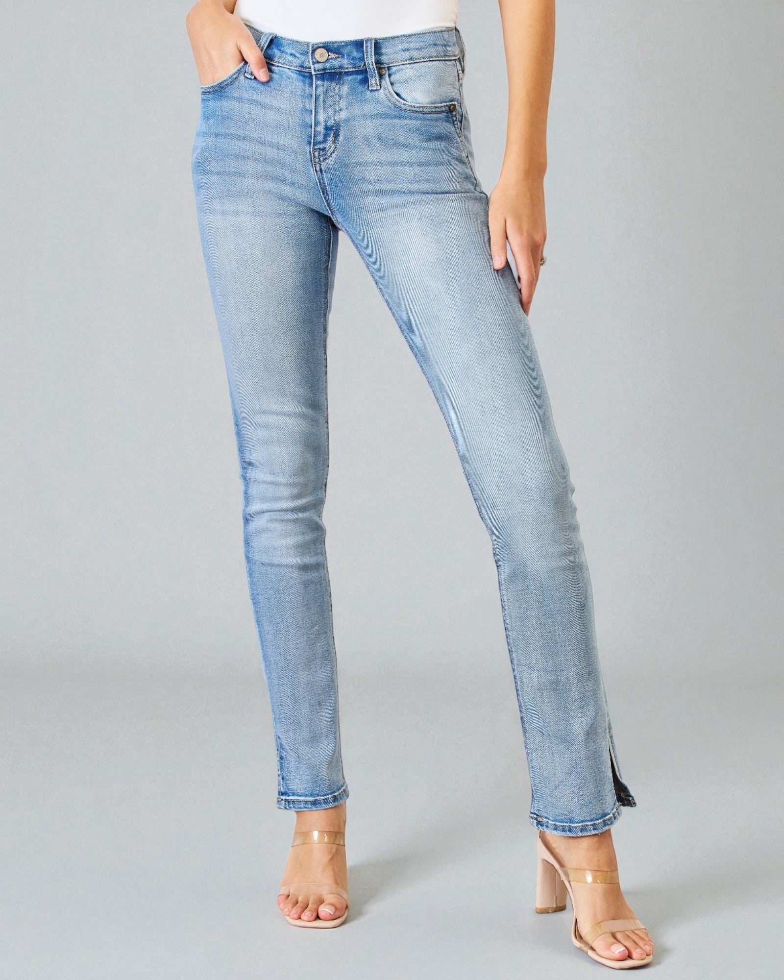 Light blue jeans worn by a person on a gray background