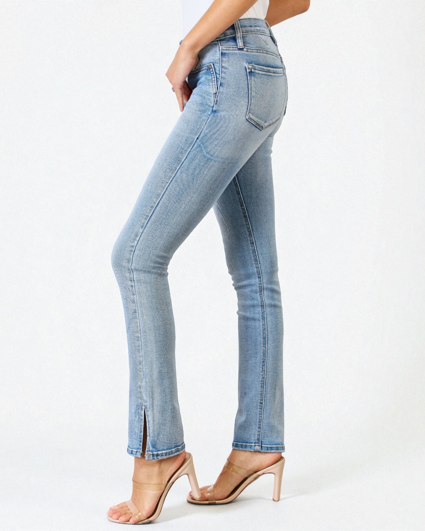 Light blue jeans worn by a person on a white background