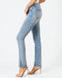 Light blue jeans worn by a person on a white background