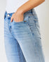 Light blue jeans worn by a person on a white background