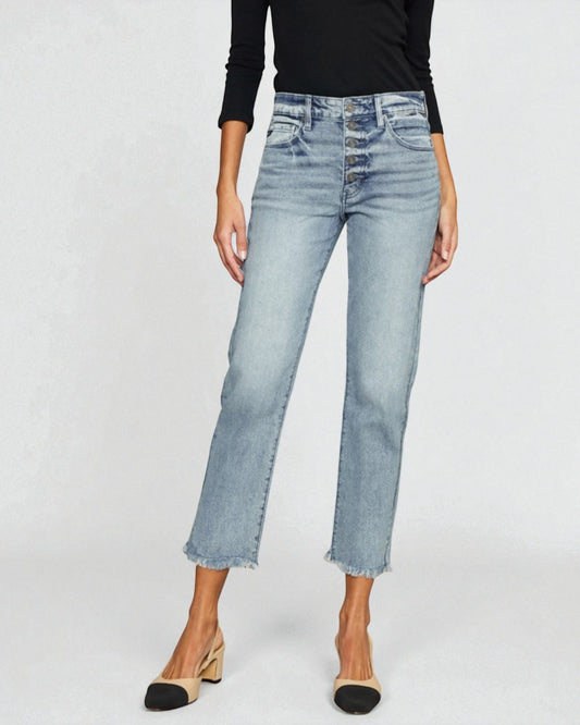 Person wearing light blue jeans on a plain background