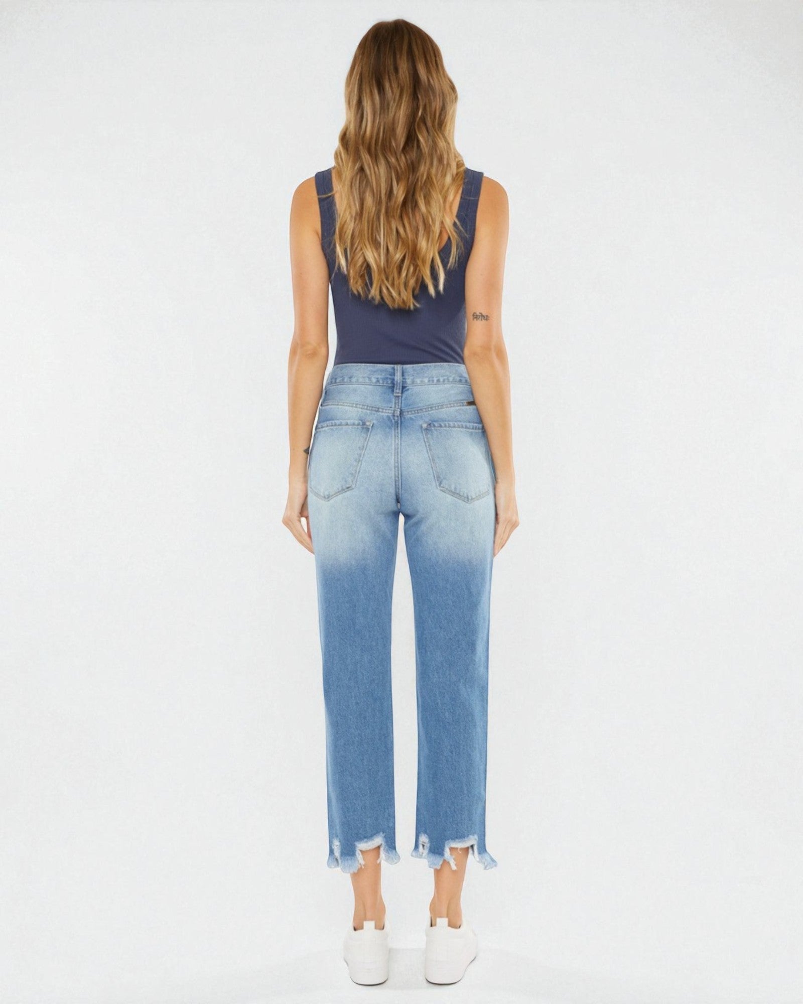 Woman wearing blue denim jeans with a white background