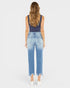 Woman wearing blue jeans and a dark top on a white background