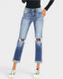 Person wearing distressed blue jeans on a white background