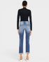 Person wearing blue jeans and a black top on a white background