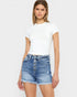 Woman wearing a white t-shirt and blue denim shorts on a white background