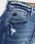 Close-up of blue jeans with a brand label on the pocket.