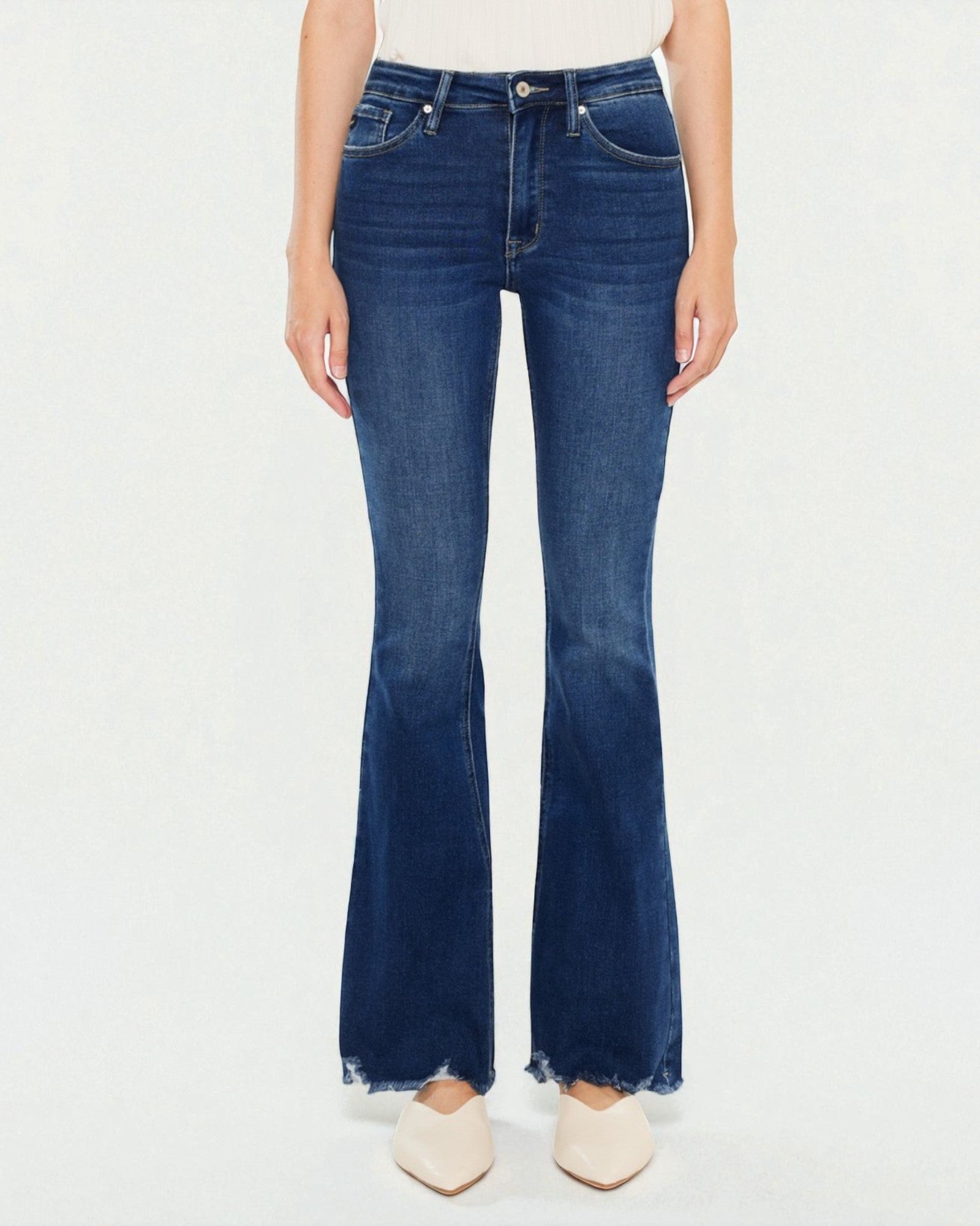 Person wearing blue flared jeans on a white background