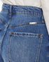 Close-up of the back waistband and pocket area of blue denim jeans, with a small white brand label reading 'kano' visible near the back pocket.