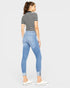 Woman wearing a striped shirt and light blue jeans on a white background
