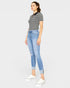 Woman wearing a striped shirt and light blue jeans on a white background