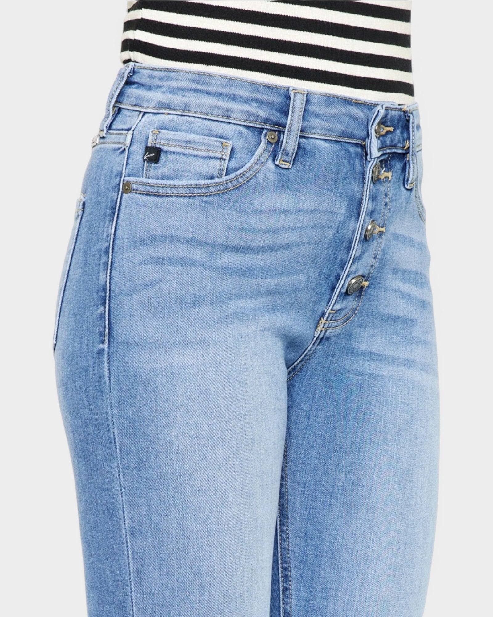 Light blue jeans with a striped shirt on a white background