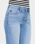 Light blue jeans with a striped shirt on a white background