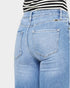 Light blue jeans worn by a person on a white background