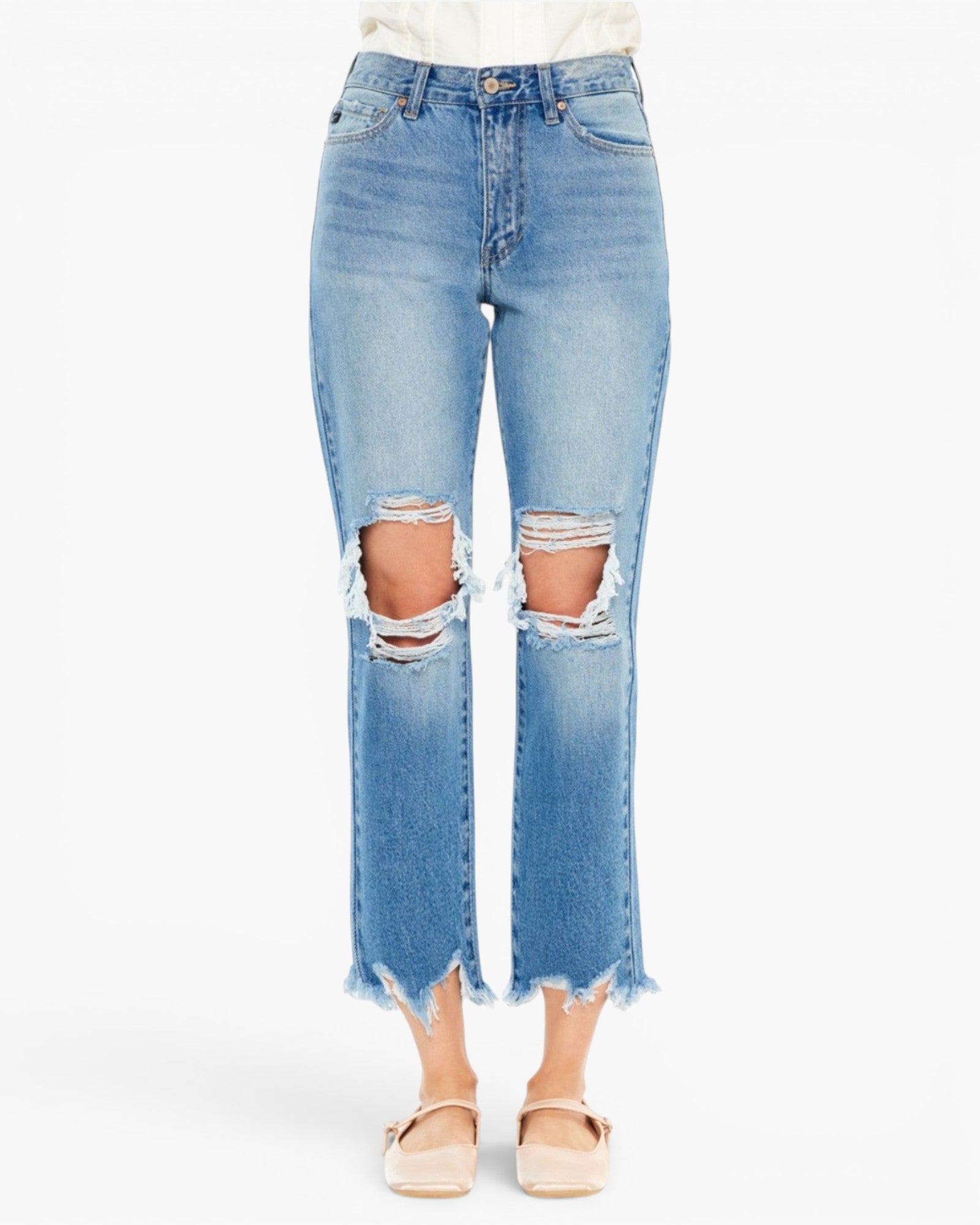 Light blue cropped denim jeans with distressed rips at the knees and frayed hems, shown on a model wearing beige flat shoes against a plain white background.