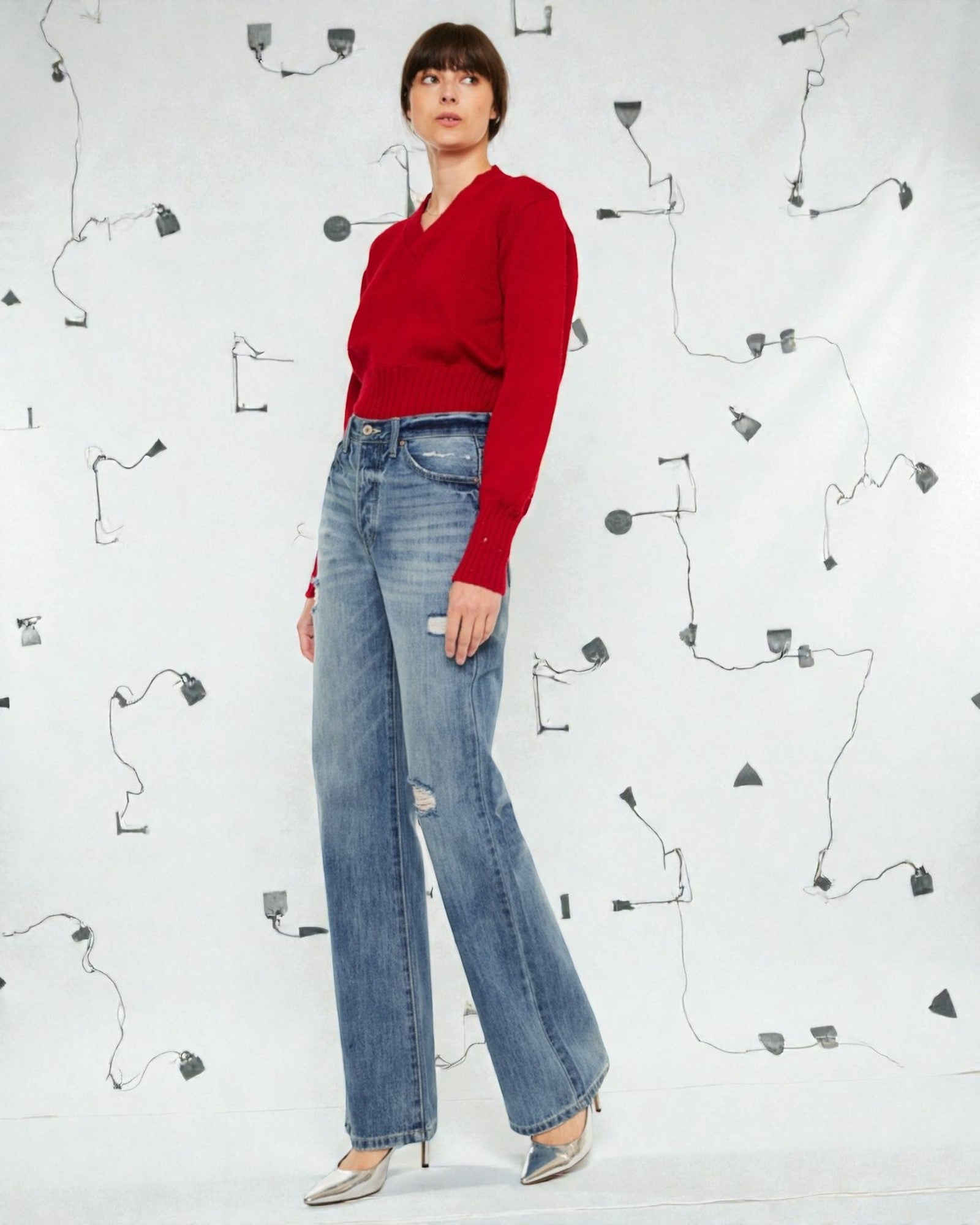 Person wearing a red sweater and blue jeans against a white background with black line art.
