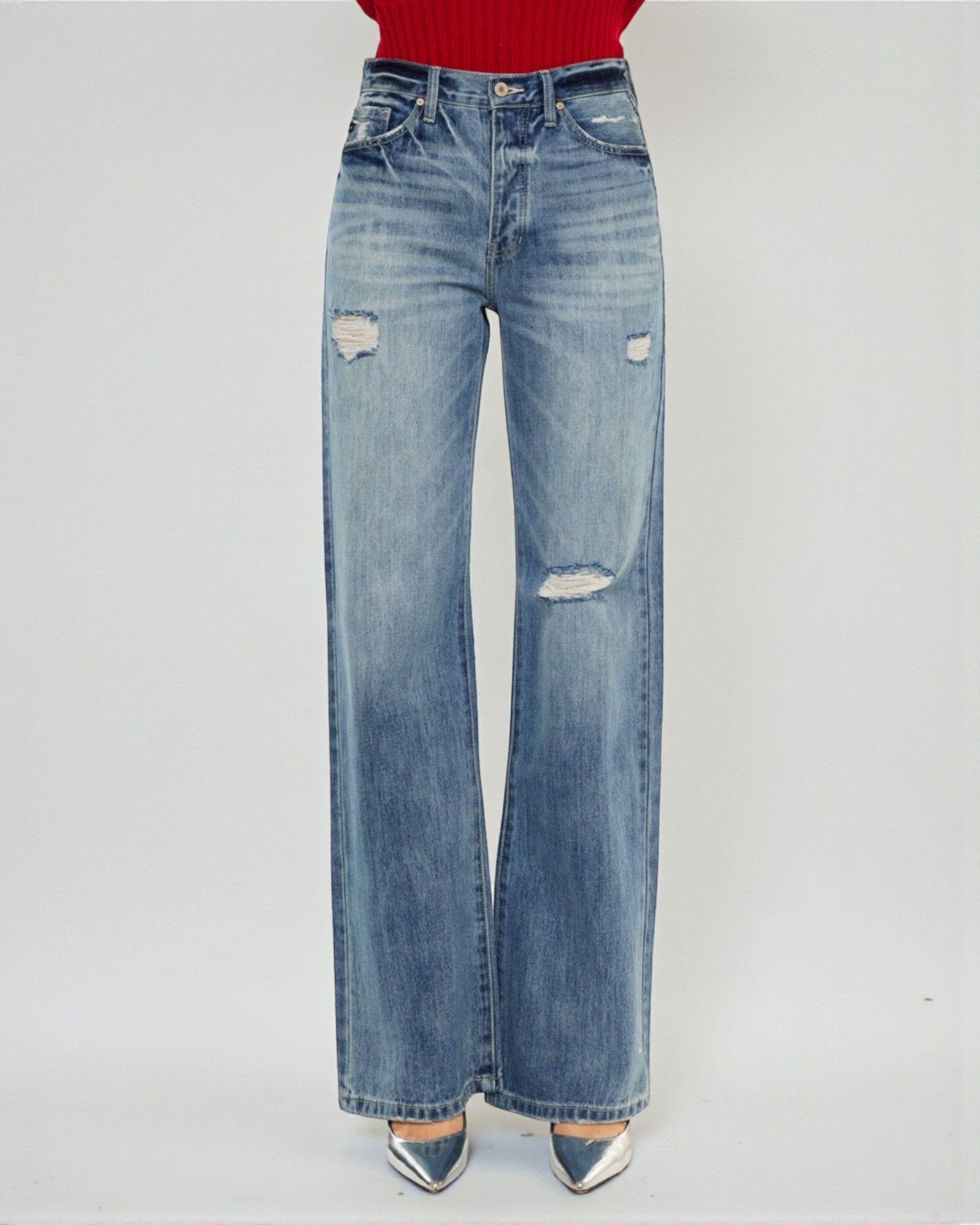 Blue jeans with slight distressing on a white background