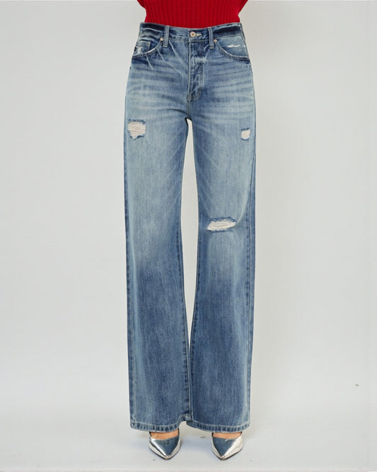 Blue jeans with slight distressing on a white background
