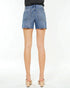 Denim shorts worn by a person on a white background