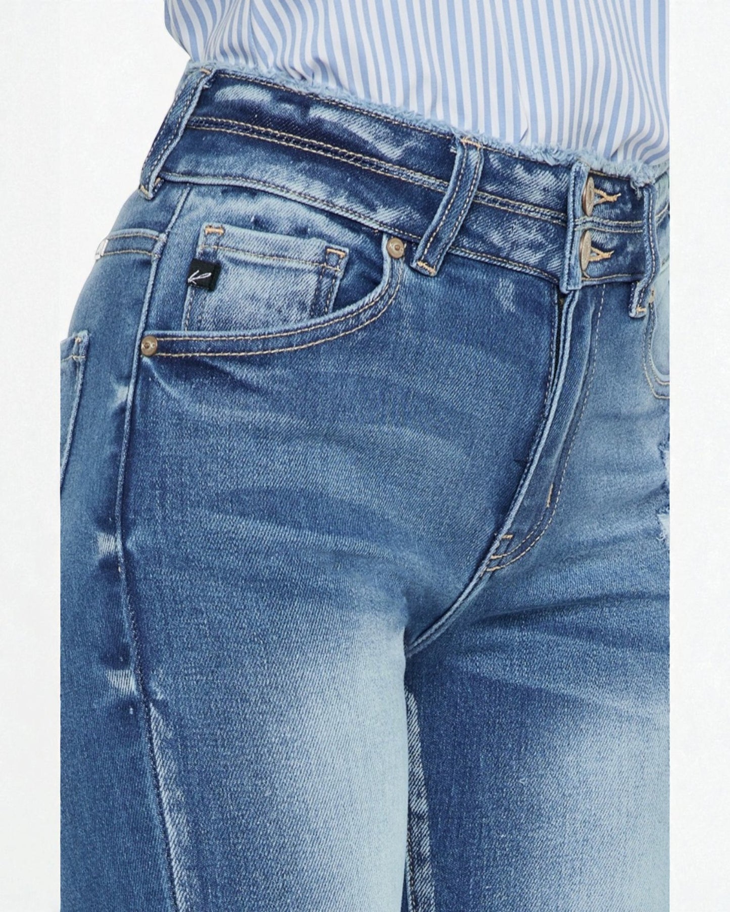 Close-up of blue jeans with a white background